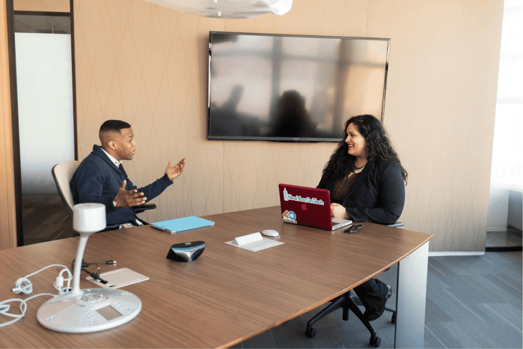 Two professionals discussing in a modern office.