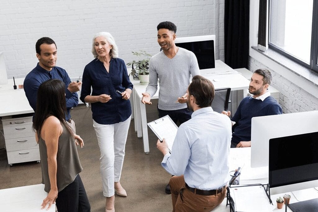 Colleagues listening to a senior executive's presentation.