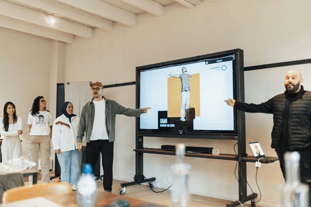 Group presentation with a large screen display.