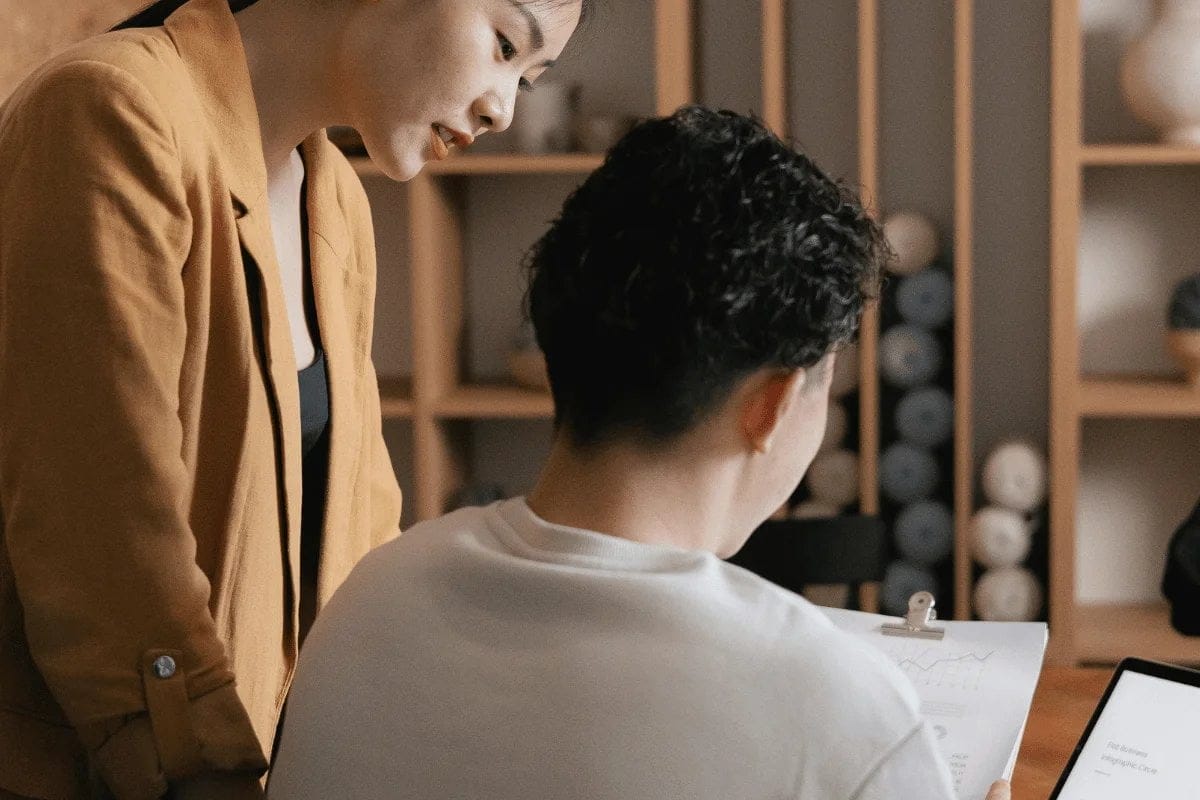 Two colleagues collaborating on a project in a modern office.