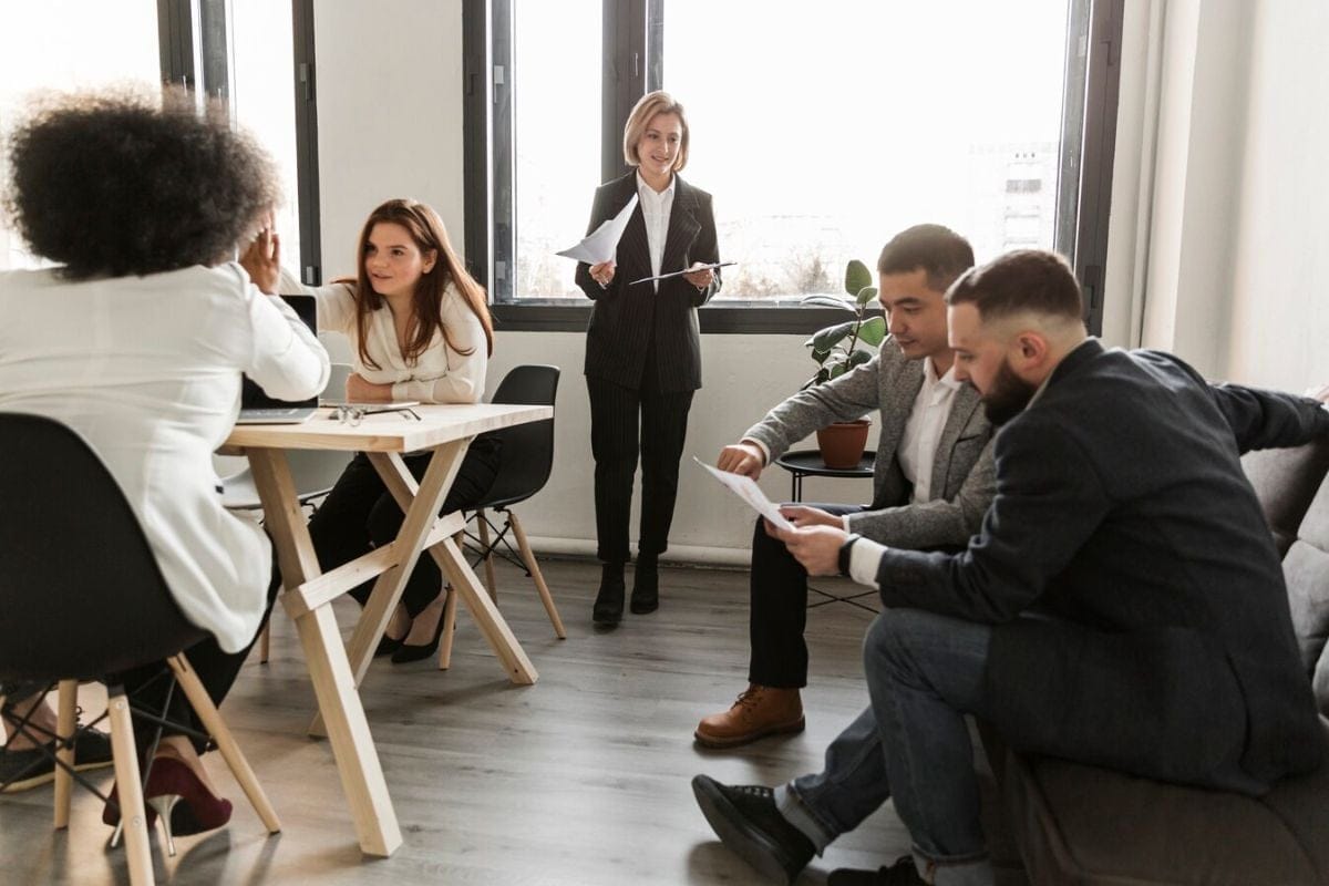 Team members discussing project details in an office setting.
