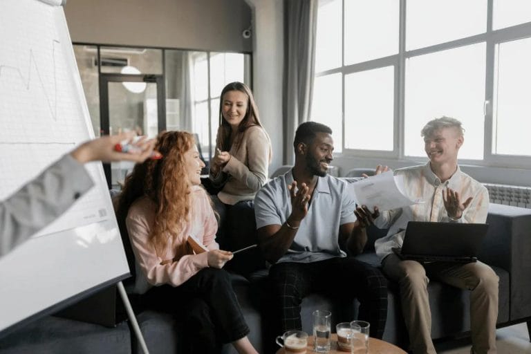 Team members sharing a light moment during a business meeting.