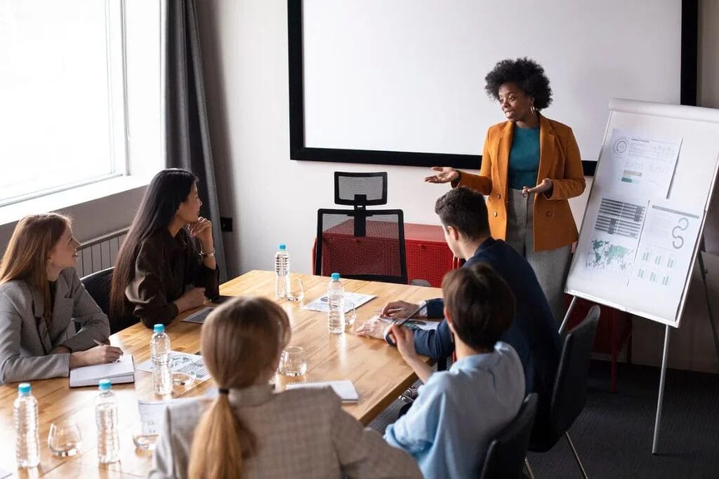 Professional team listening to a female presenter.