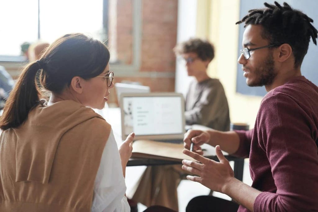 Team members having a focused conversation in an office.