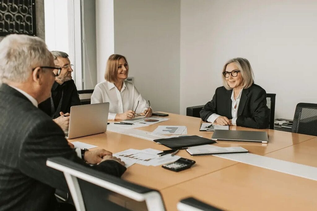 Business professionals having a discussion during a meeting in a modern conference room.