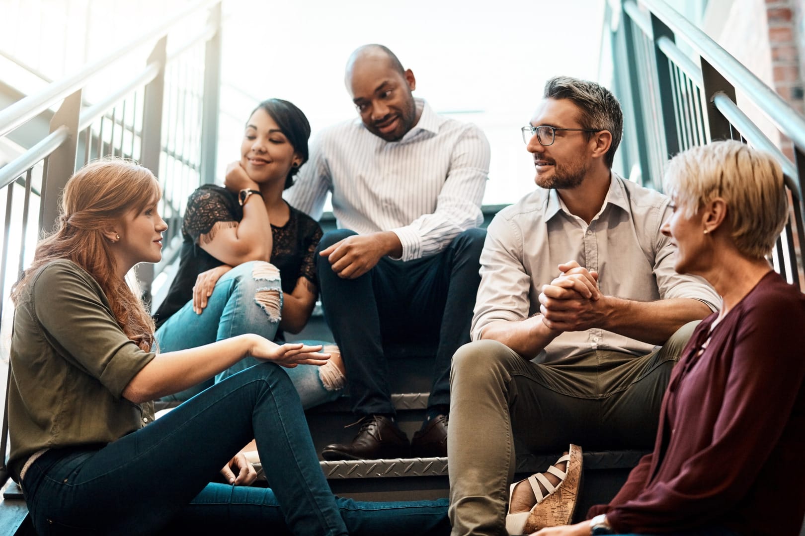 A coach guides a team using active listening to foster trust and collaboration.