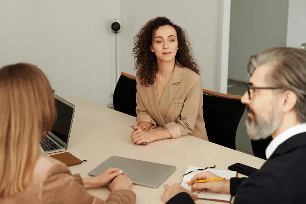 Business meeting with a thoughtful woman at the table.