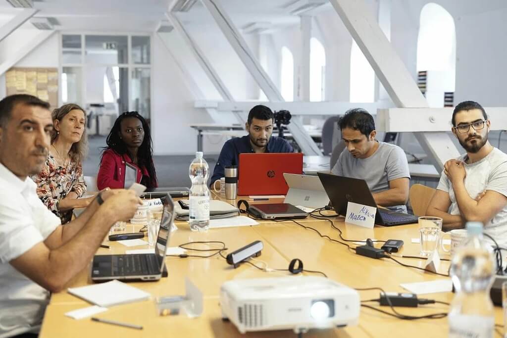 Diverse team in a meeting, focused on a project discussion.