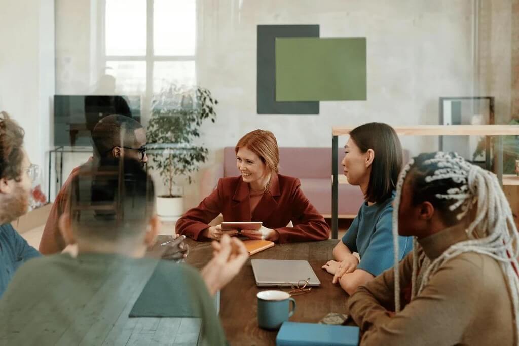 A group of colleagues having a meeting around a table.