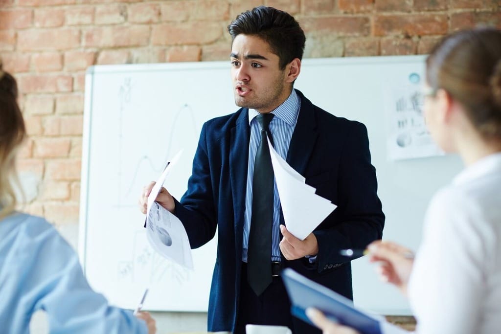 Businessman presenting data to colleagues in a meeting.