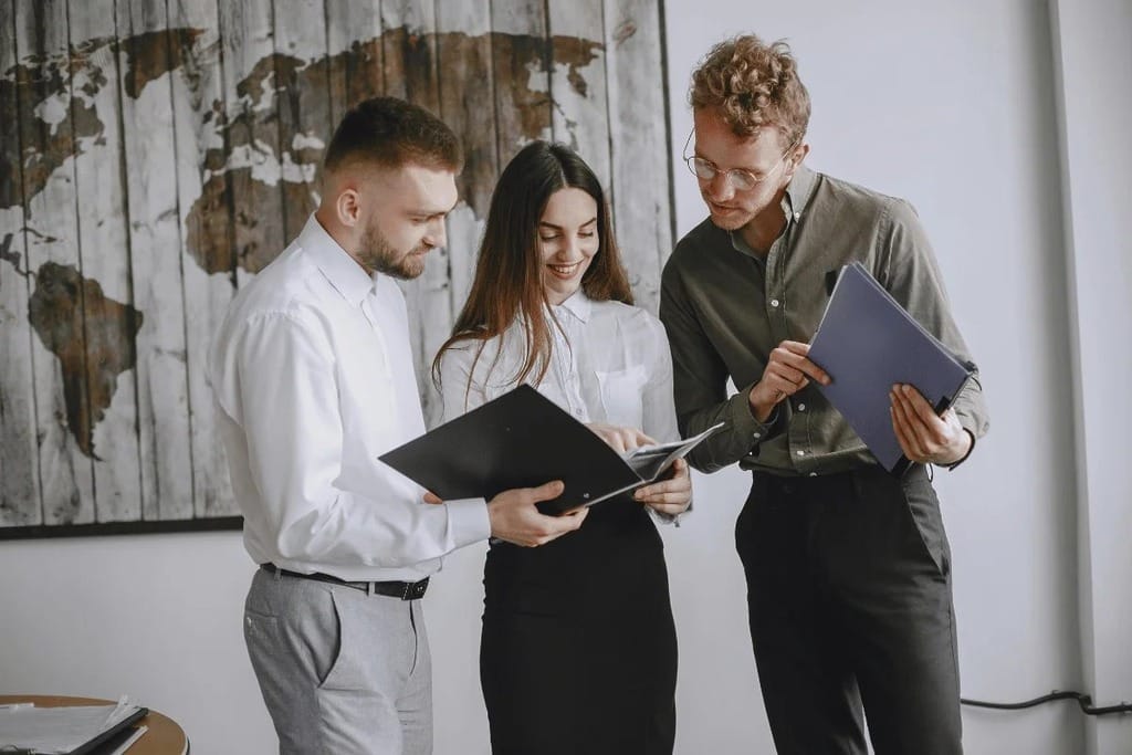 Three colleagues collaborating in an office.