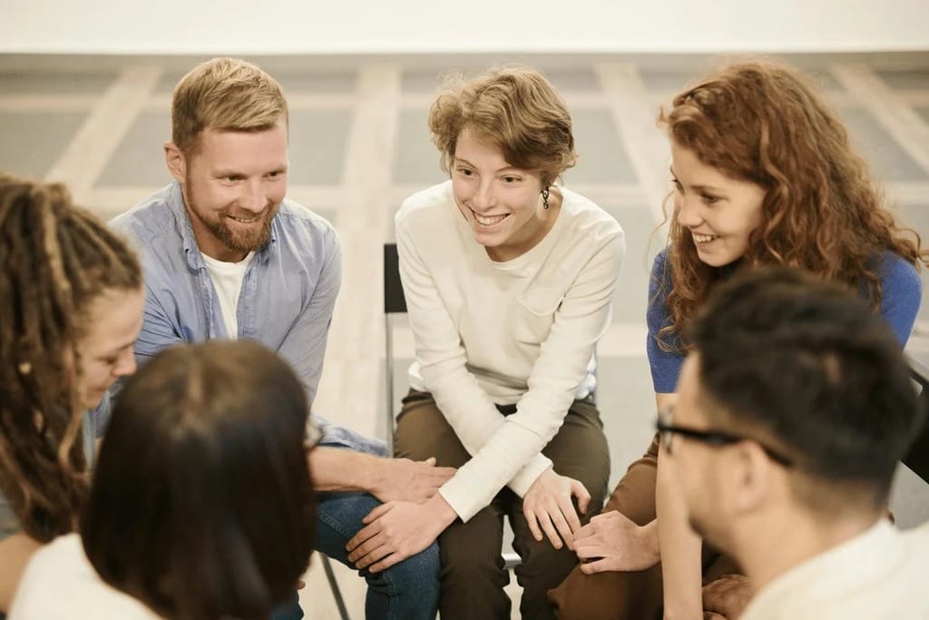 Group of colleagues engaged in a focused discussion during a meeting.