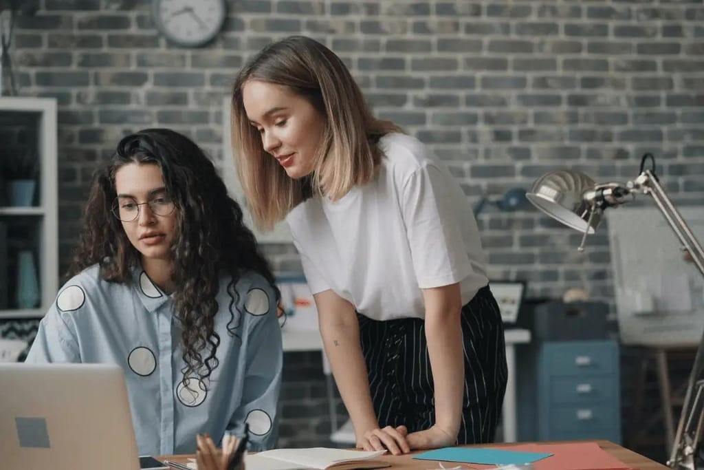 Creative professionals collaborating on a design project in an office.