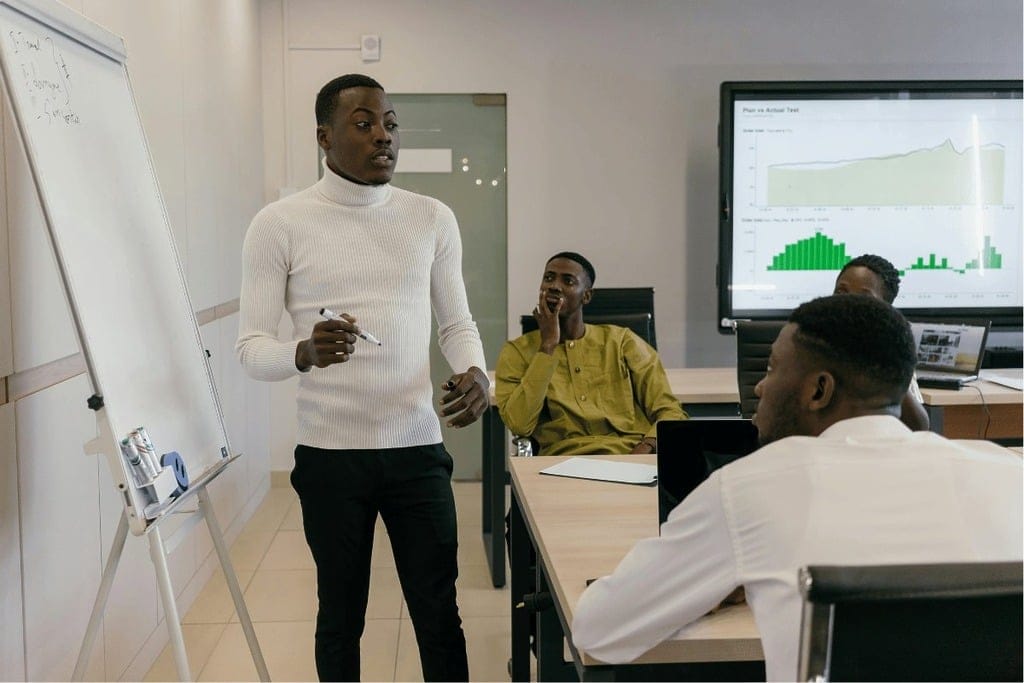 Business meeting with a presenter explaining charts to attentive team members.