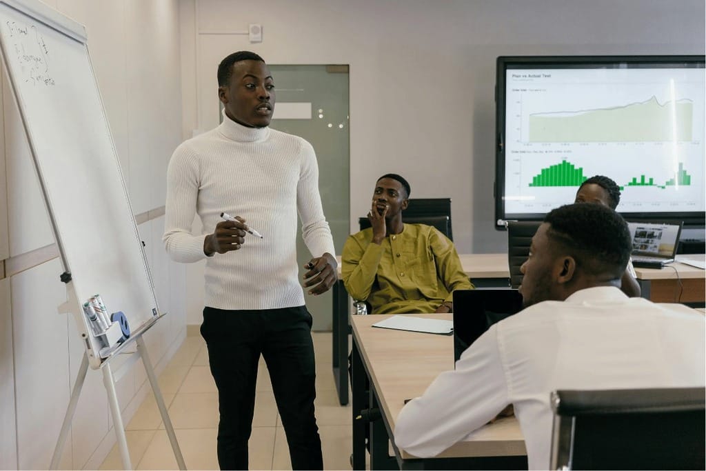 Business meeting with a presenter explaining charts to attentive team members.