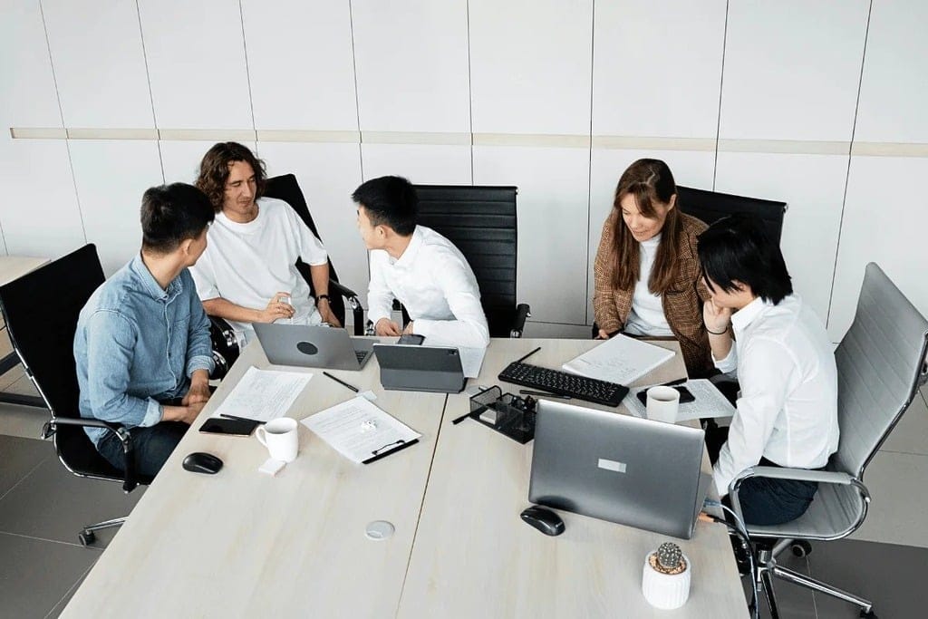 A woman presenting a flowchart during a business meeting.