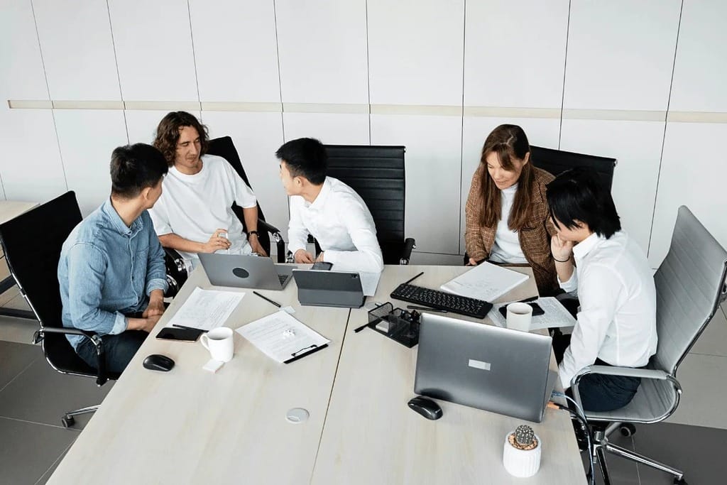A woman presenting a flowchart during a business meeting.