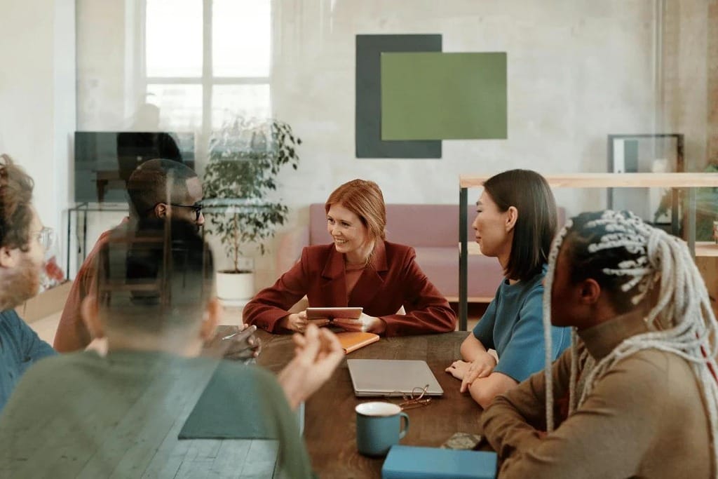 Colleagues sharing ideas in a modern office environment.