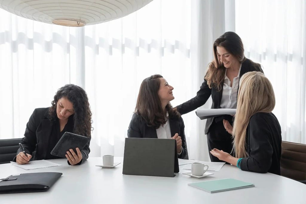 Corporate leader addressing team members during a business meeting.