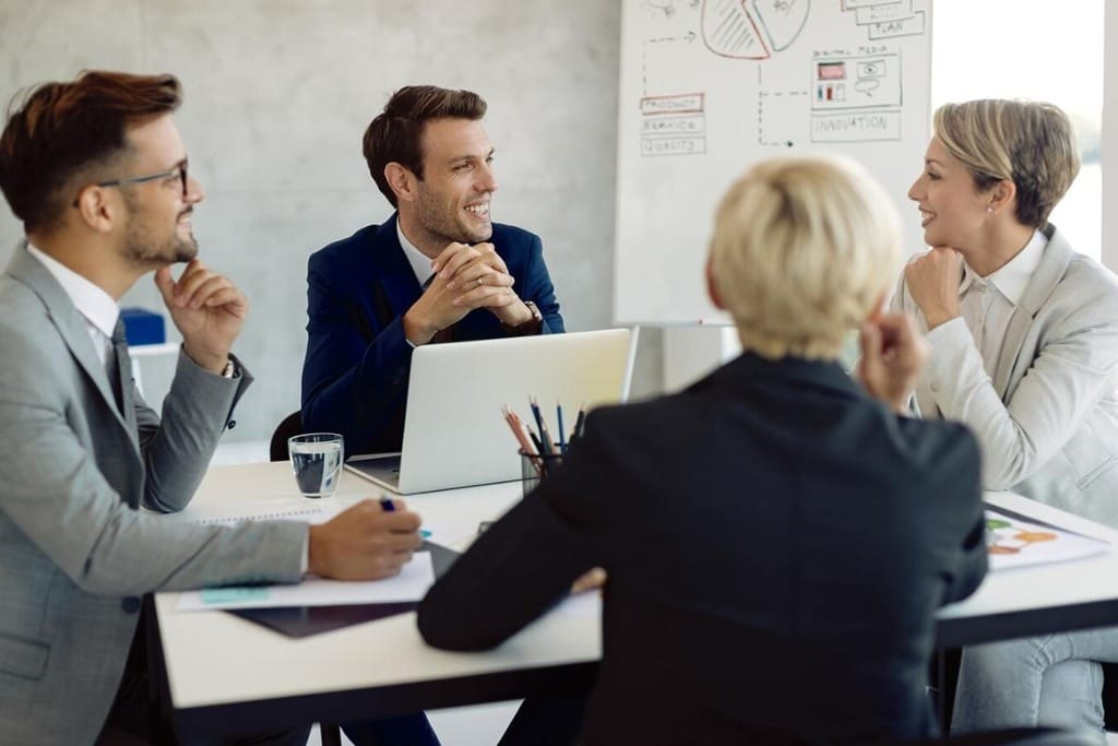 Team members discussing strategy in a professional setting.